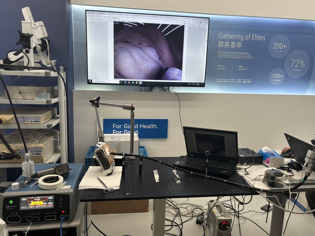 Laparoscopic instrument test bench with a mounted instrument, laptop, and endoscopic video display